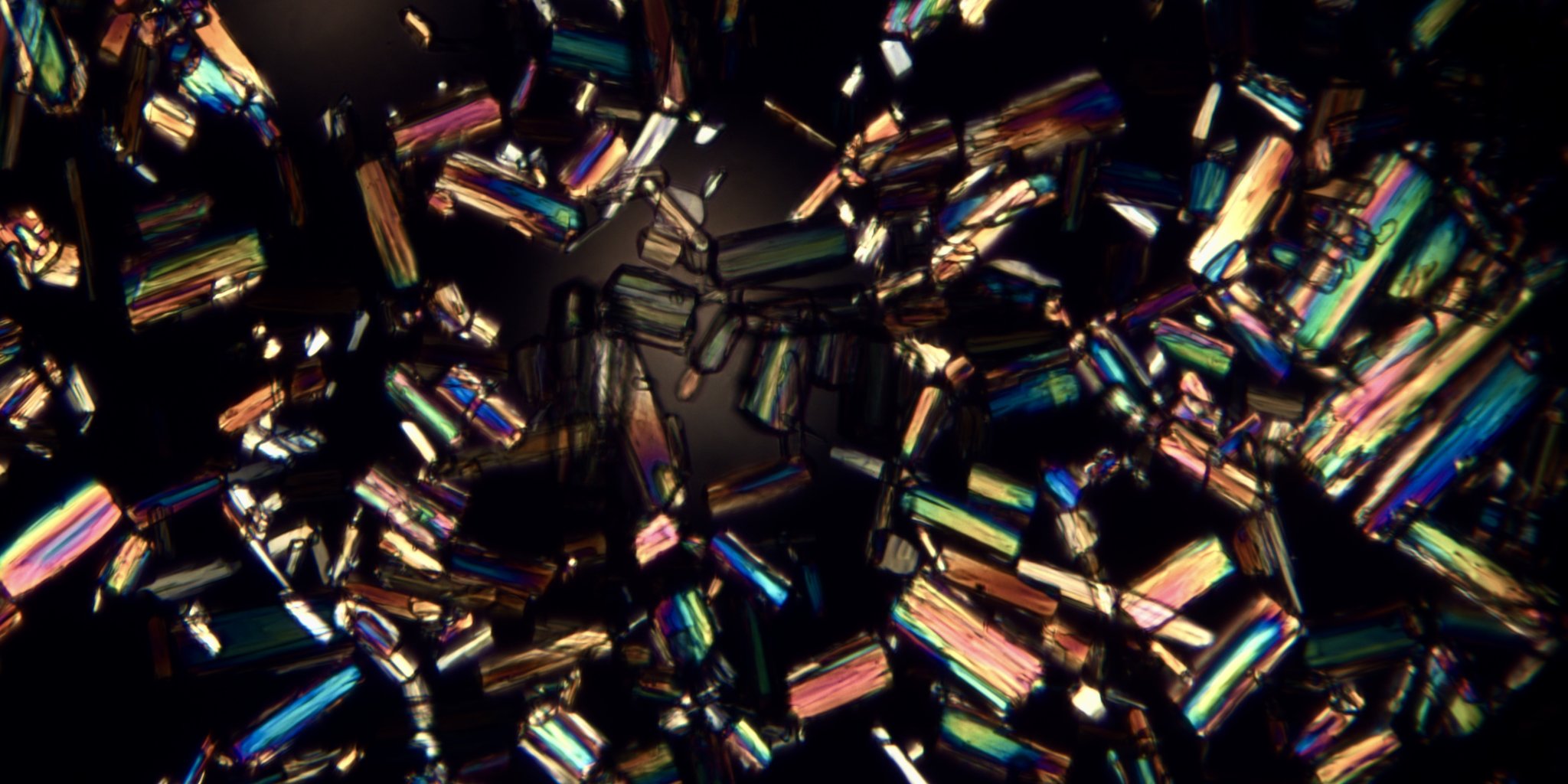 Wide field of layered crystal growth in copper and blue tones formed from cremated remains